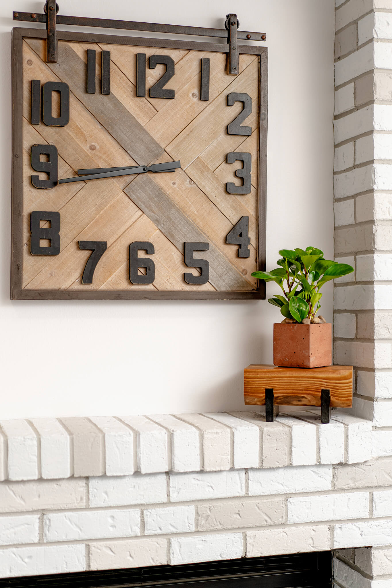 Image of a Pine plant stand against a brick wall, with a succulent plant placed on it. The stand, treated with a stain and hard-wax oil, reveals rich wood grain texture and an elevated design.